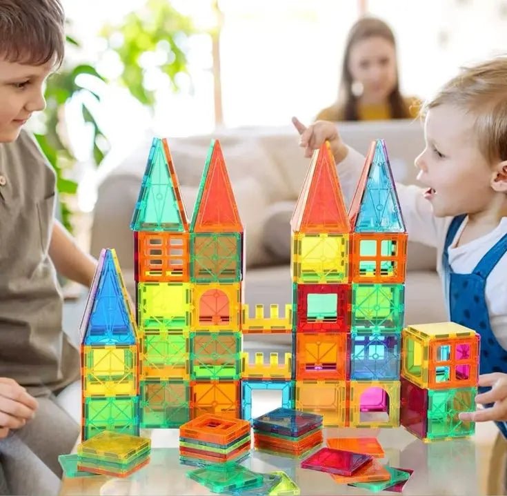 Child building with magnetic tiles